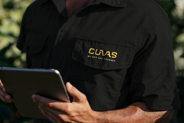 Black work shirt with the CUVAS logo and payoff embroidered on the chest pocket